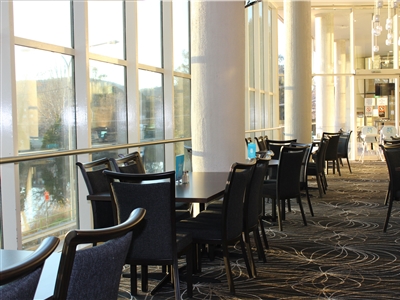 The Leagues on The River dining room, with floor-to-ceiling windows
